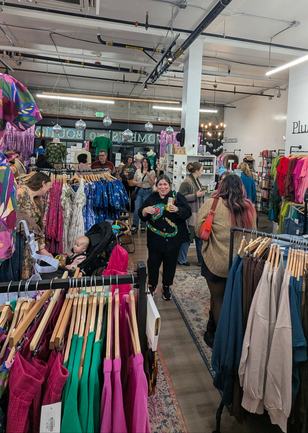Interior of a clothing store with racks of clothes and people shopping renton seattle wa