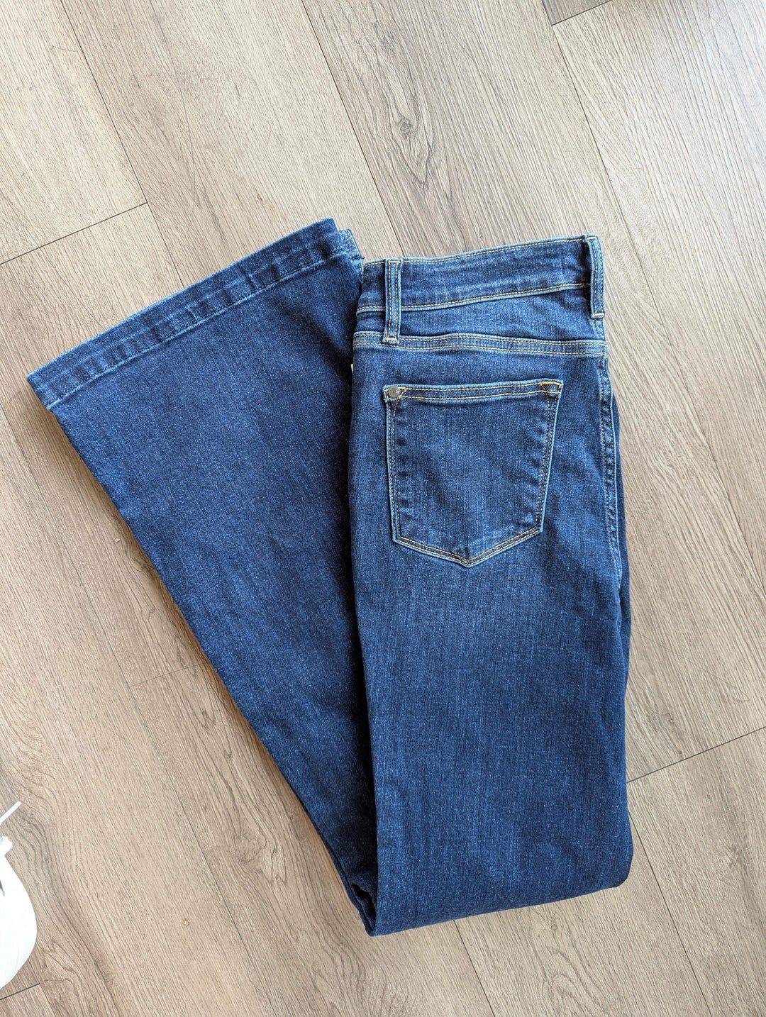 judy blue jeans flare leg folded in half laying on floor with back side pockets showing