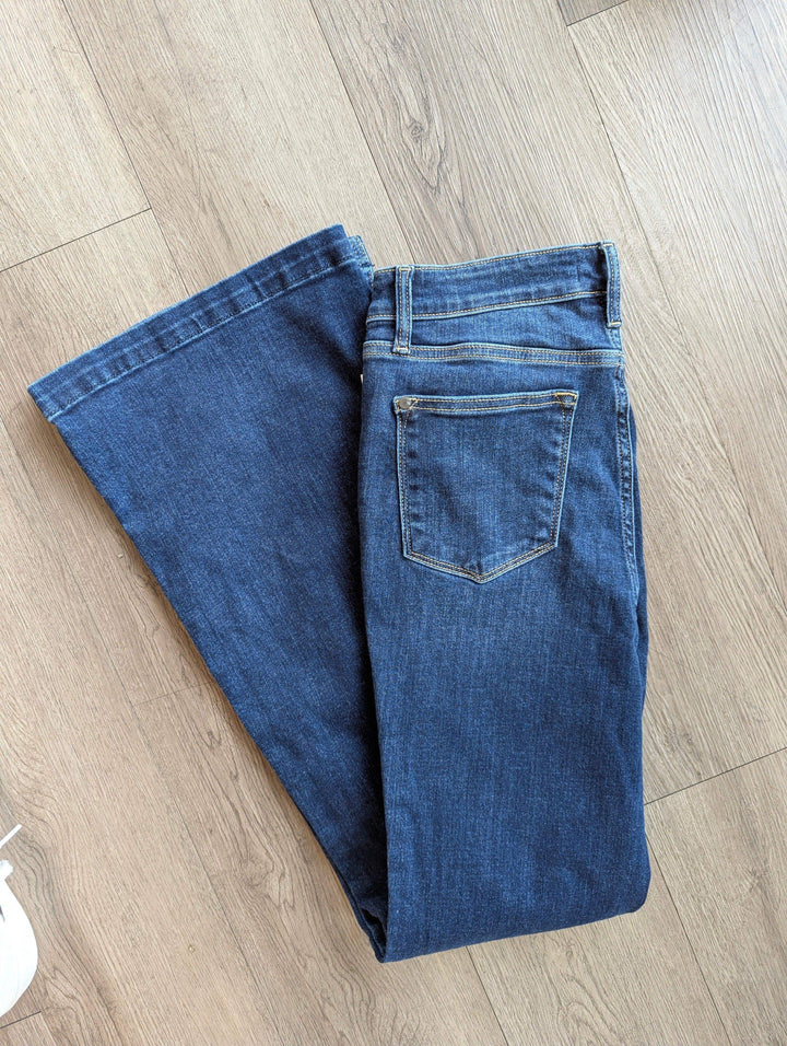 judy blue jeans flare leg folded in half laying on floor with back side pockets showing