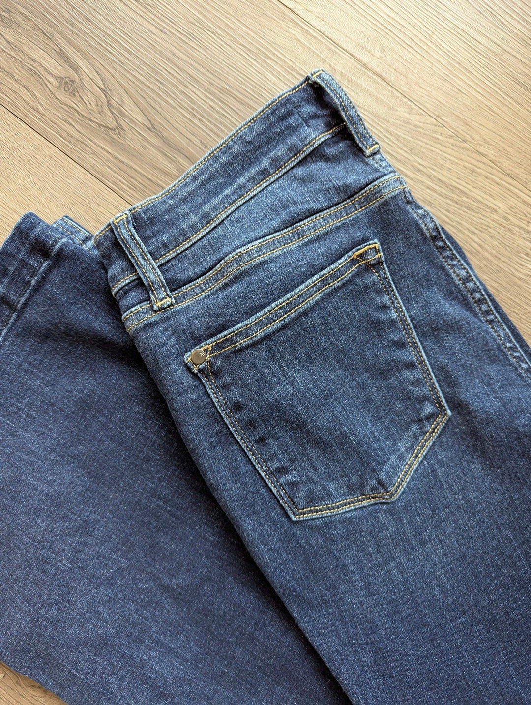 close up of back of flare jeans of pockets on the back side