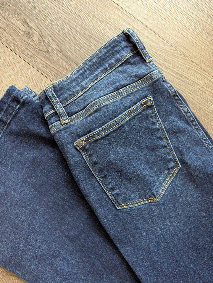 close up of back of flare jeans of pockets on the back side