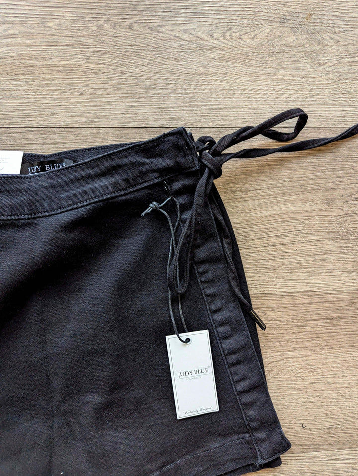 close up of tie on black judy blue skort laid on the floor