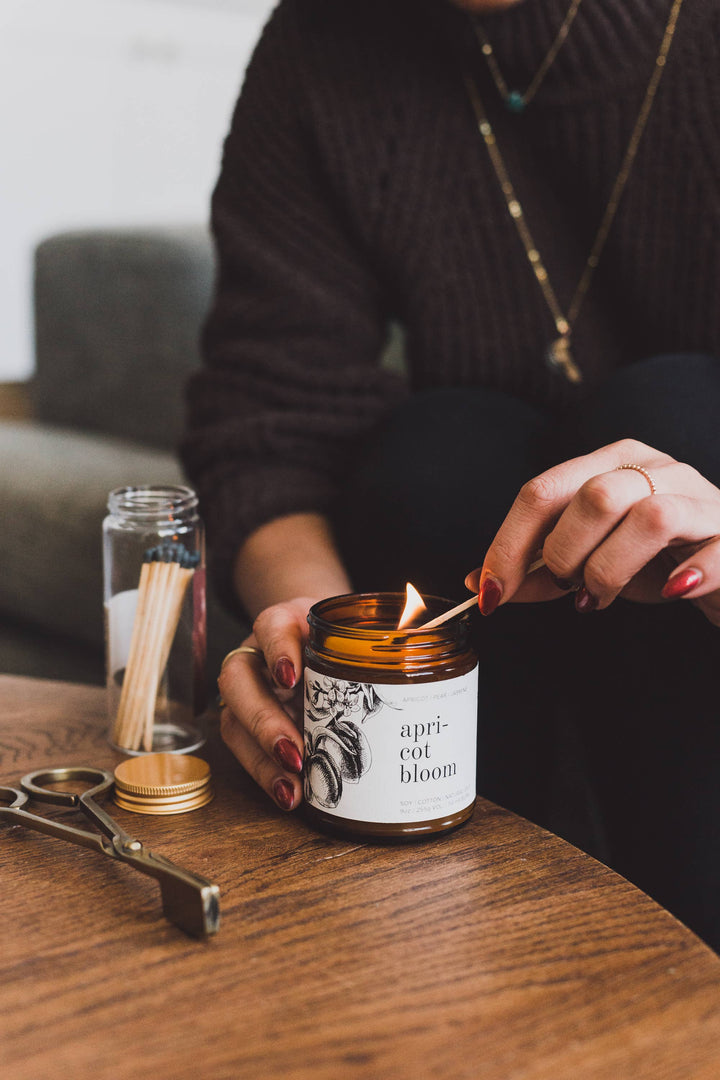 woman hand lighting natural spring candle
