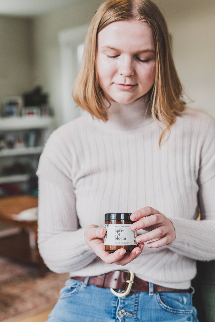 woman holding small 4ox spring candle