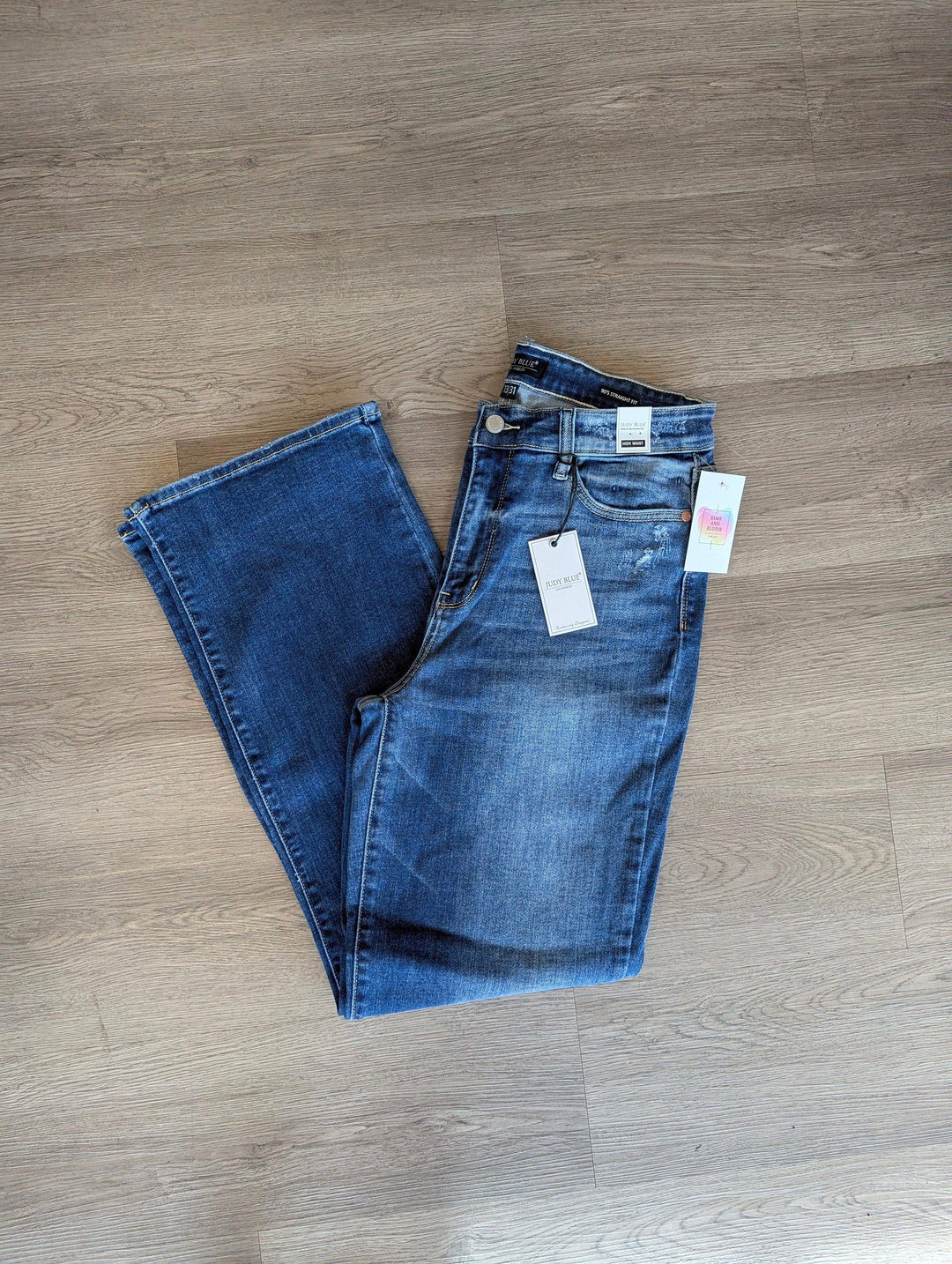 straight leg judy blue jeans folded in half so you can see the single leg medium wash on floor