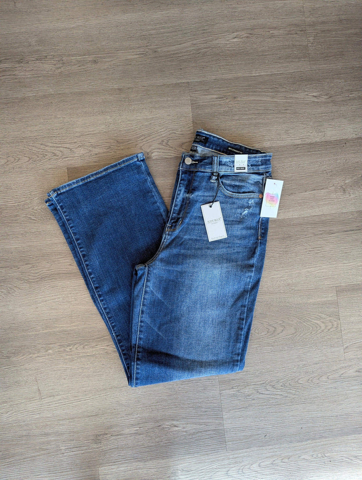 straight leg judy blue jeans folded in half so you can see the single leg medium wash on floor