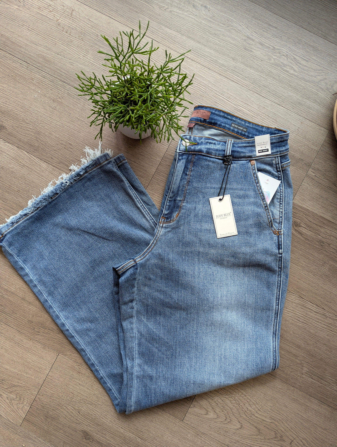 folded judy blue jeans in half flat lay